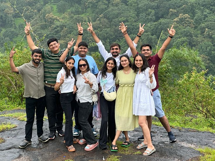 A group of travellers celebrating on a green hillside